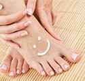 Foot with a smiley-face made of lotion