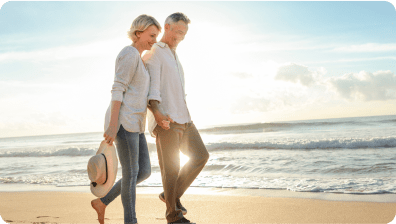 Happy couple walking on beach